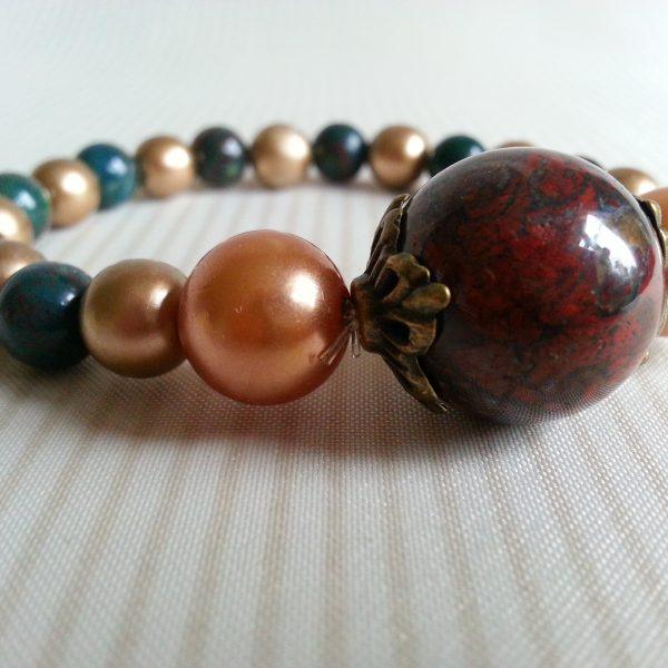 Beaded elasticated bracelet gold green and red